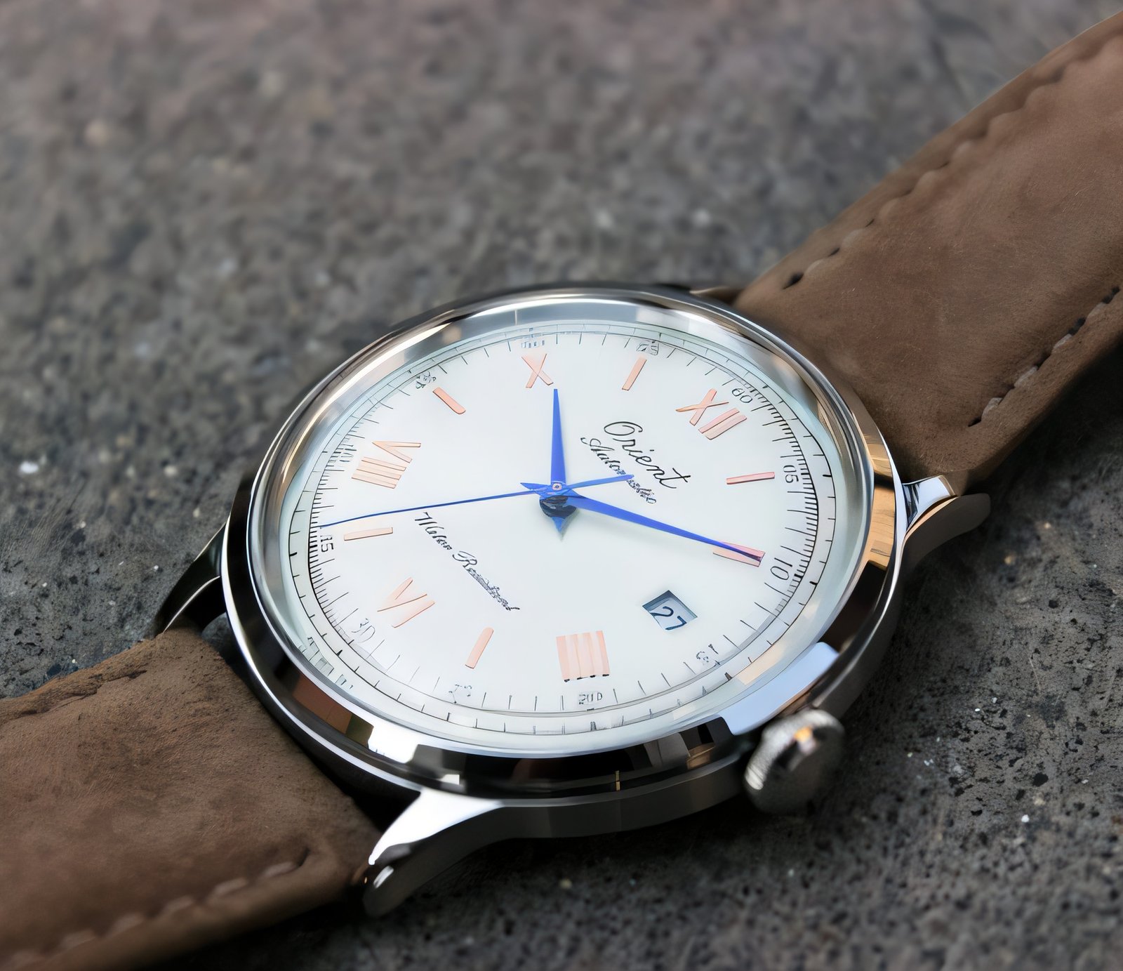 Blue hands and rose-gold-tone roman numerals on the Orient Bambino 75th dial