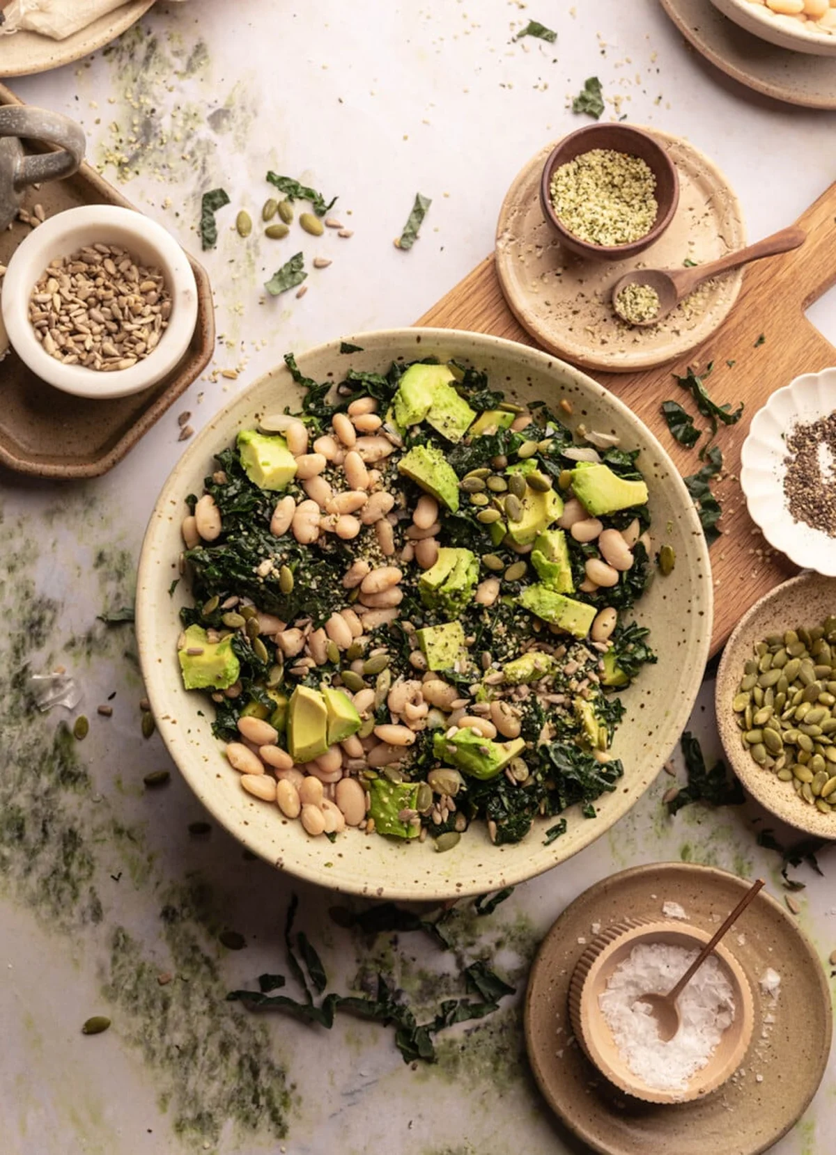 Salad bowl with kale, white beans, avocado, and seeds