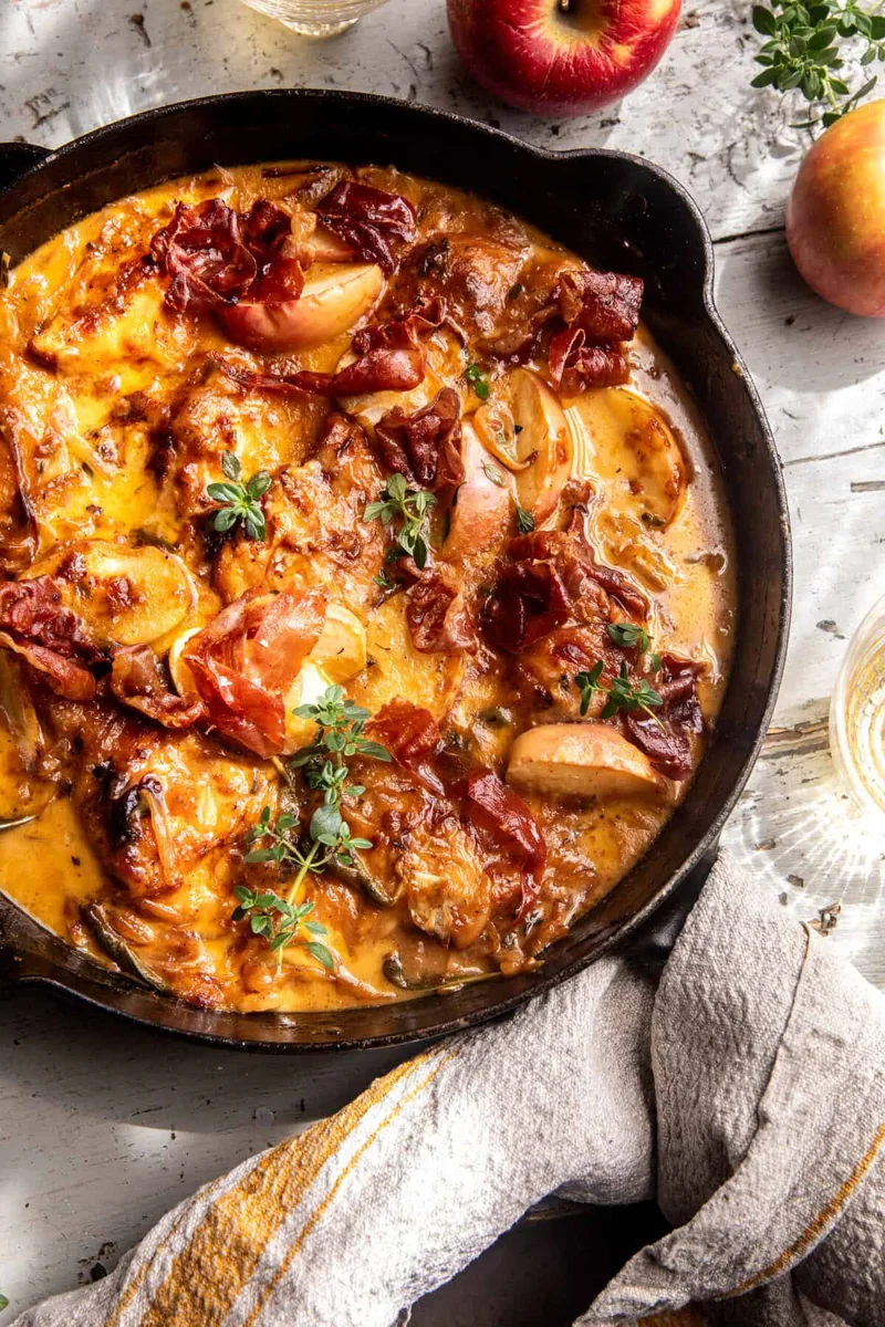 Apple cider smothered chicken in a cast iron skillet