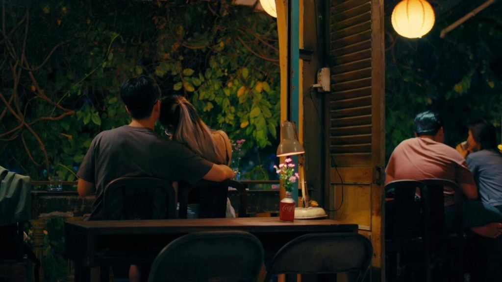 Couple sharing a quiet evening at an outdoor cafe table