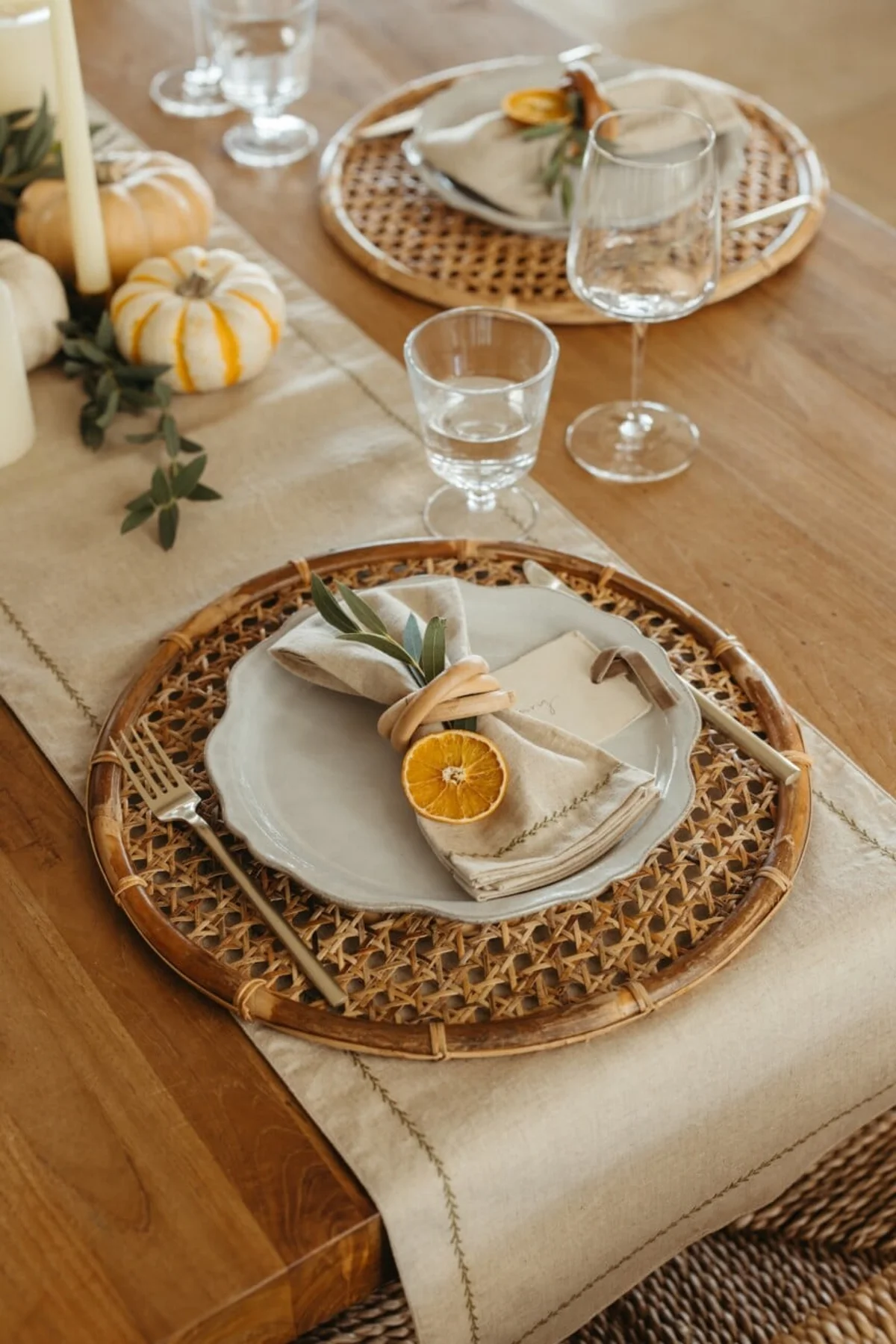 Close-up of a warm Thanksgiving table setting with candles